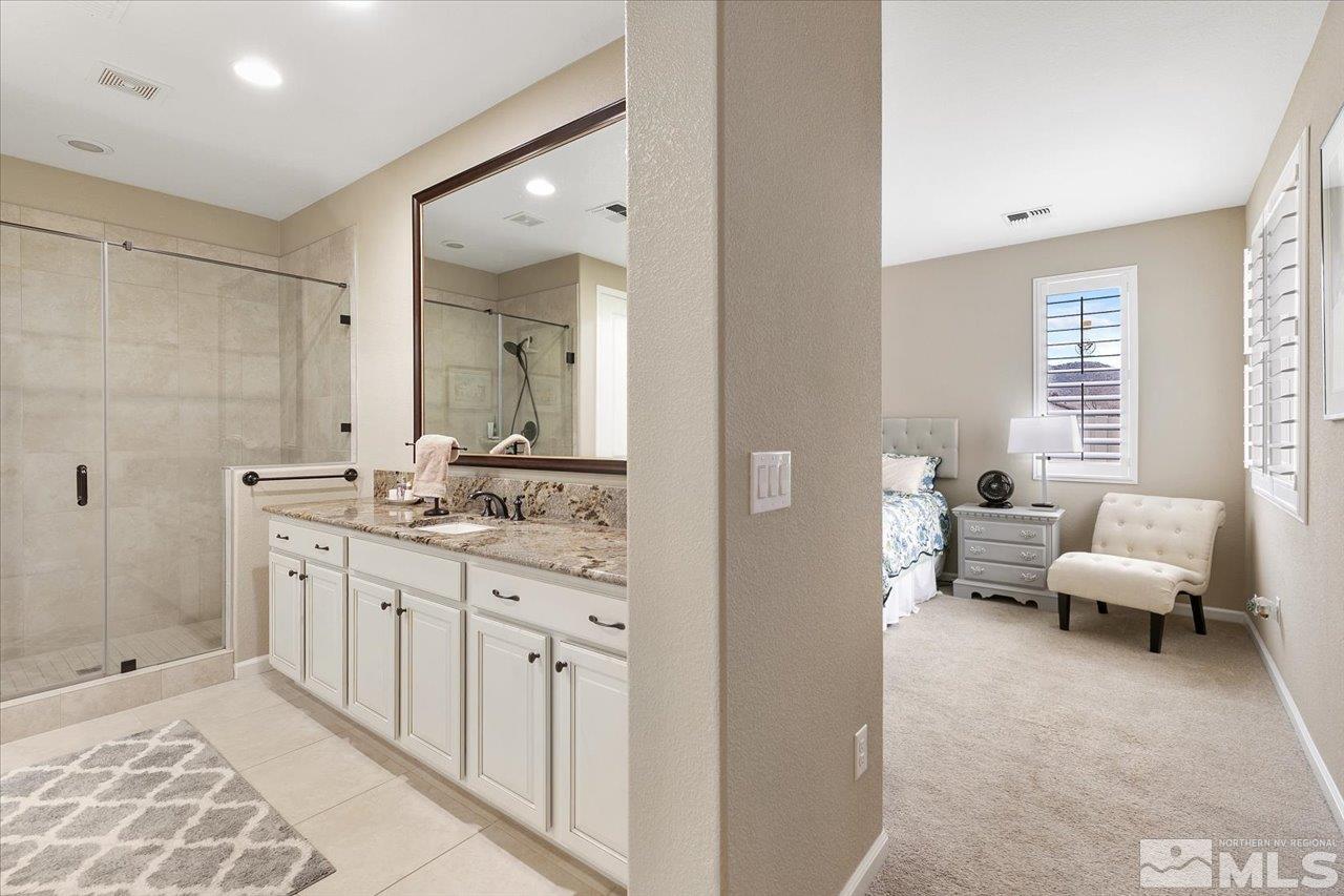 2280 Trakehner Lane Reno, NV 89521 - Photo 12 of 24 a spacious bathroom with a double vanity sink and mirror