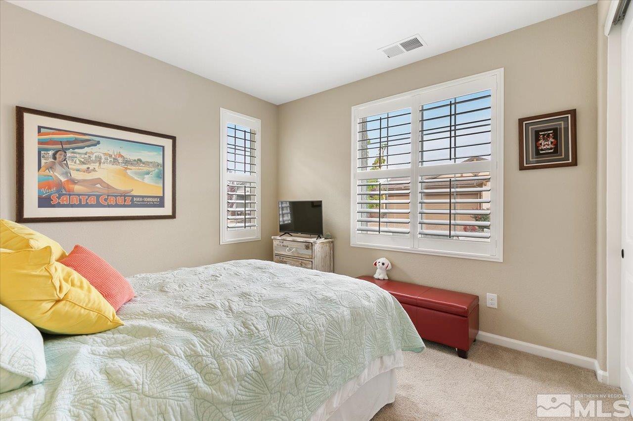 2280 Trakehner Lane Reno, NV 89521 - Photo 15 of 24 a spacious bedroom with a bed and a window