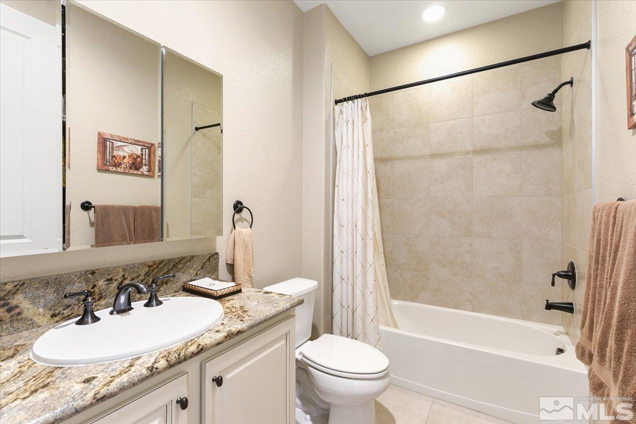 2280 Trakehner Lane Reno, NV 89521 - Photo 16 of 24 a bathroom with a granite countertop sink toilet and shower
