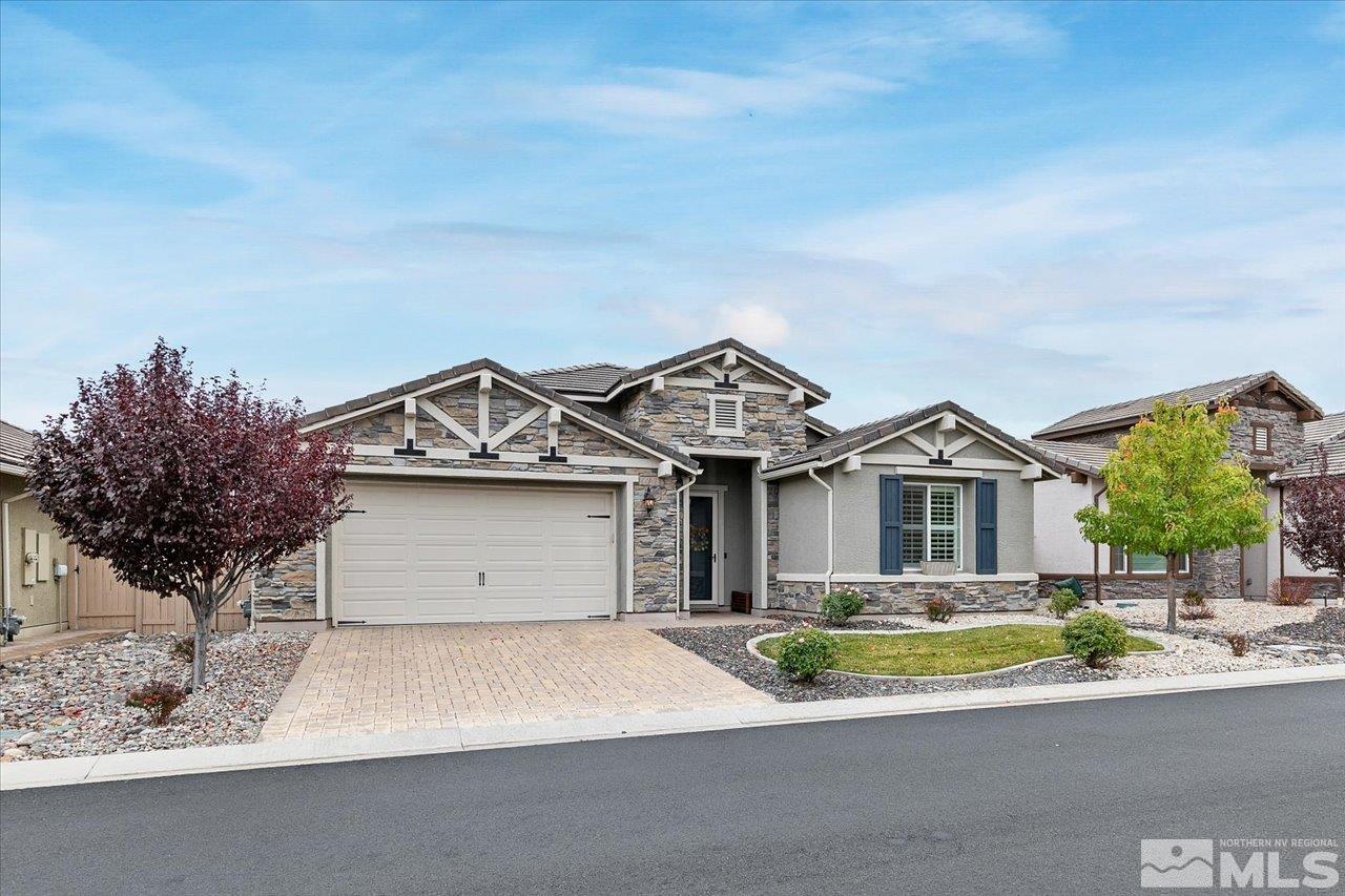 2280 Trakehner Lane Reno, NV 89521 - Photo 2 of 24 a front view of a house with a garden and garage