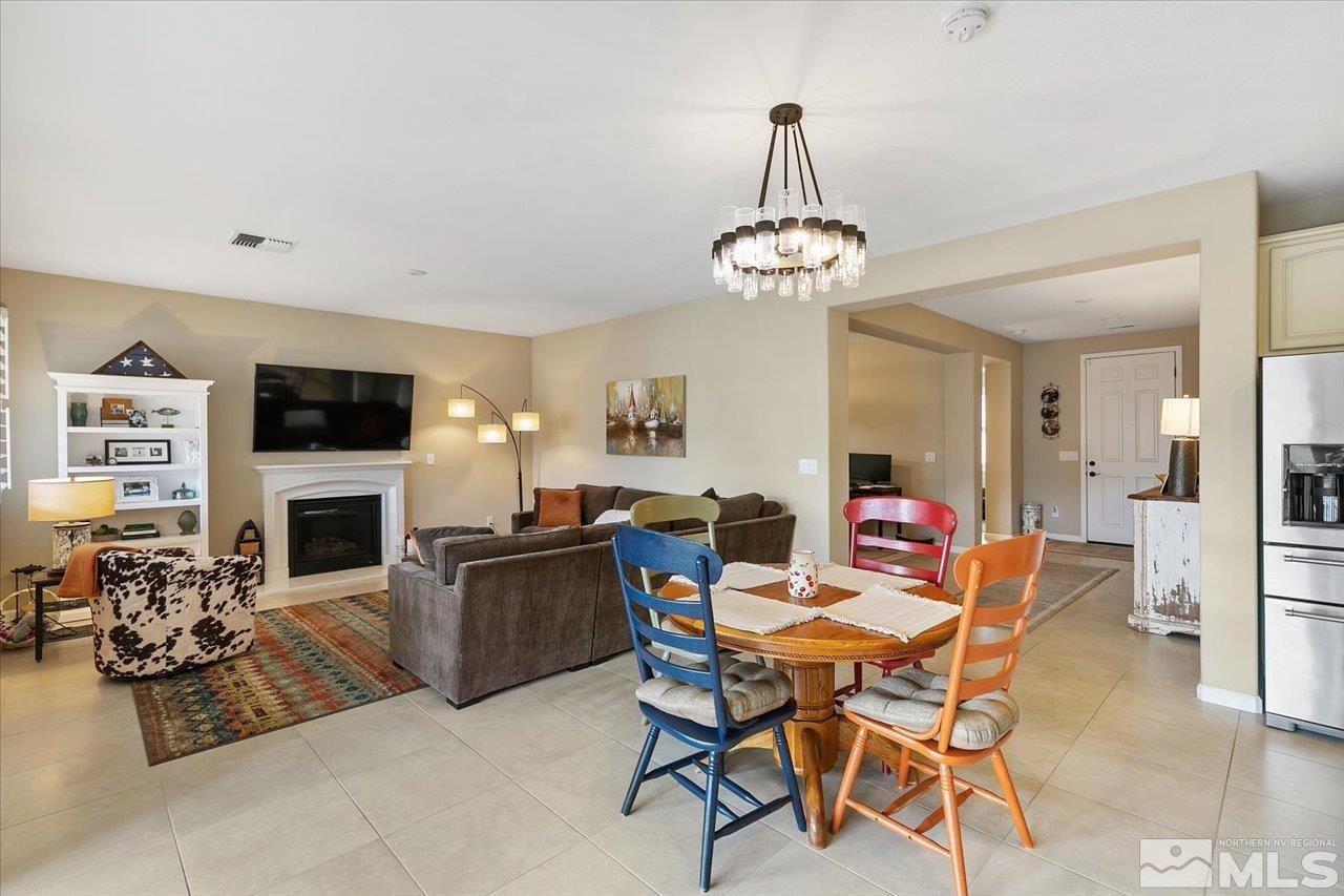 2280 Trakehner Lane Reno, NV 89521 - Photo 5 of 24 a view of a dining room with furniture wooden floor and a chandelier