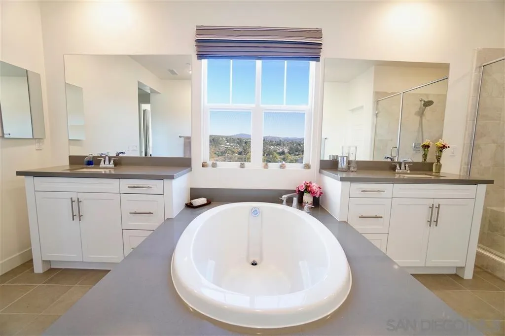 8831 Weston Road Santee, CA 92071 - Photo 12 of 25 a bathroom with a sink a window and a mirror