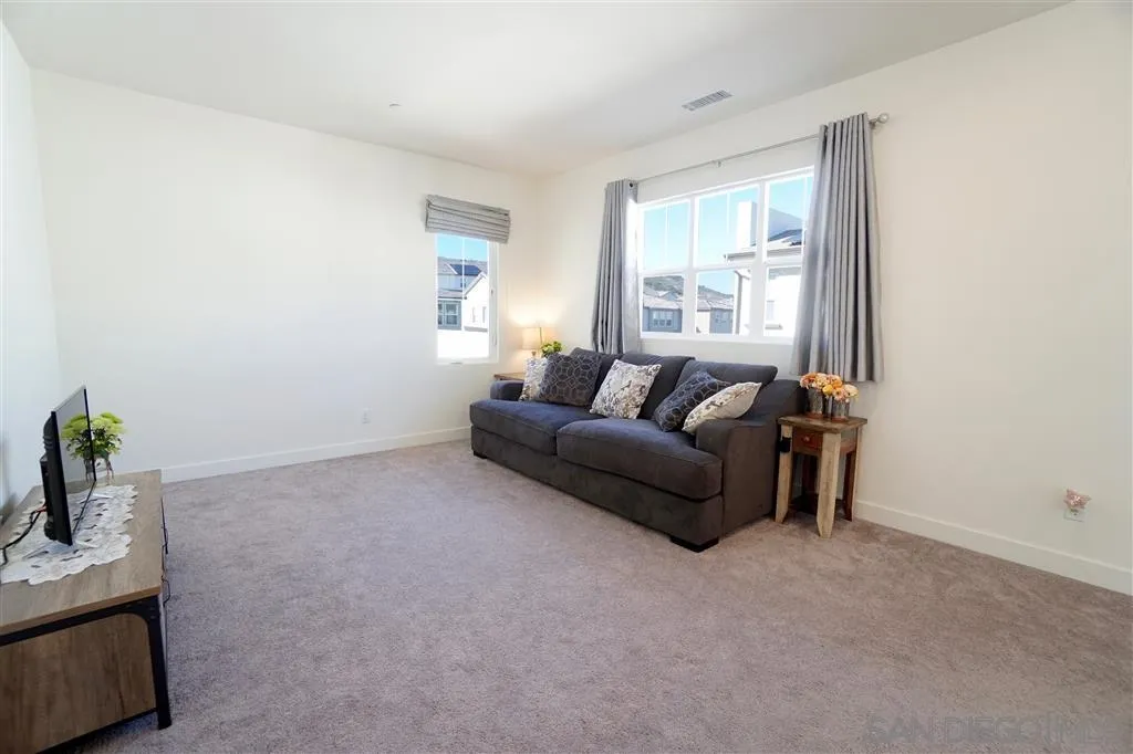 8831 Weston Road Santee, CA 92071 - Photo 14 of 25 a living room with furniture and potted plant
