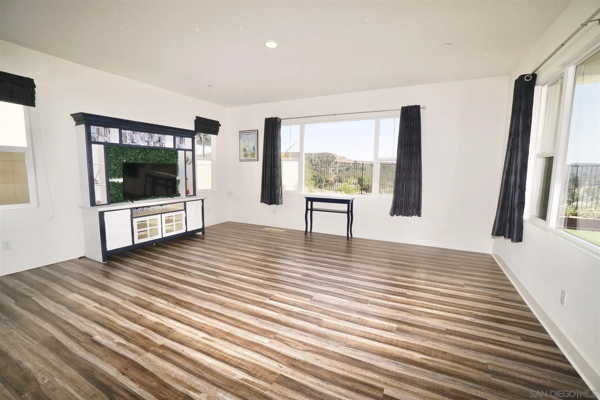 8831 Weston Road Santee, CA 92071 - Photo 4 of 25 a view of an empty room with a window and wooden floor