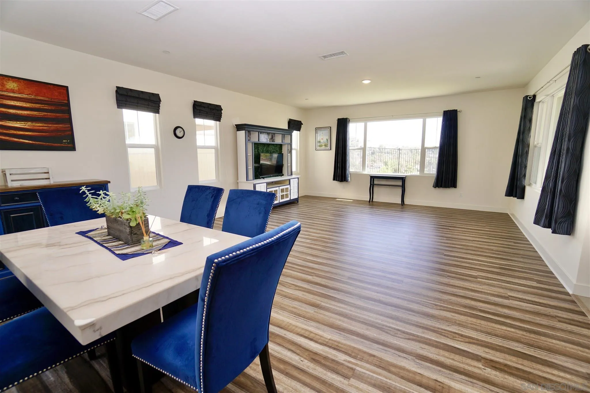 8831 Weston Road Santee, CA 92071 - Photo 5 of 25 a view of a dining room with furniture and wooden floor