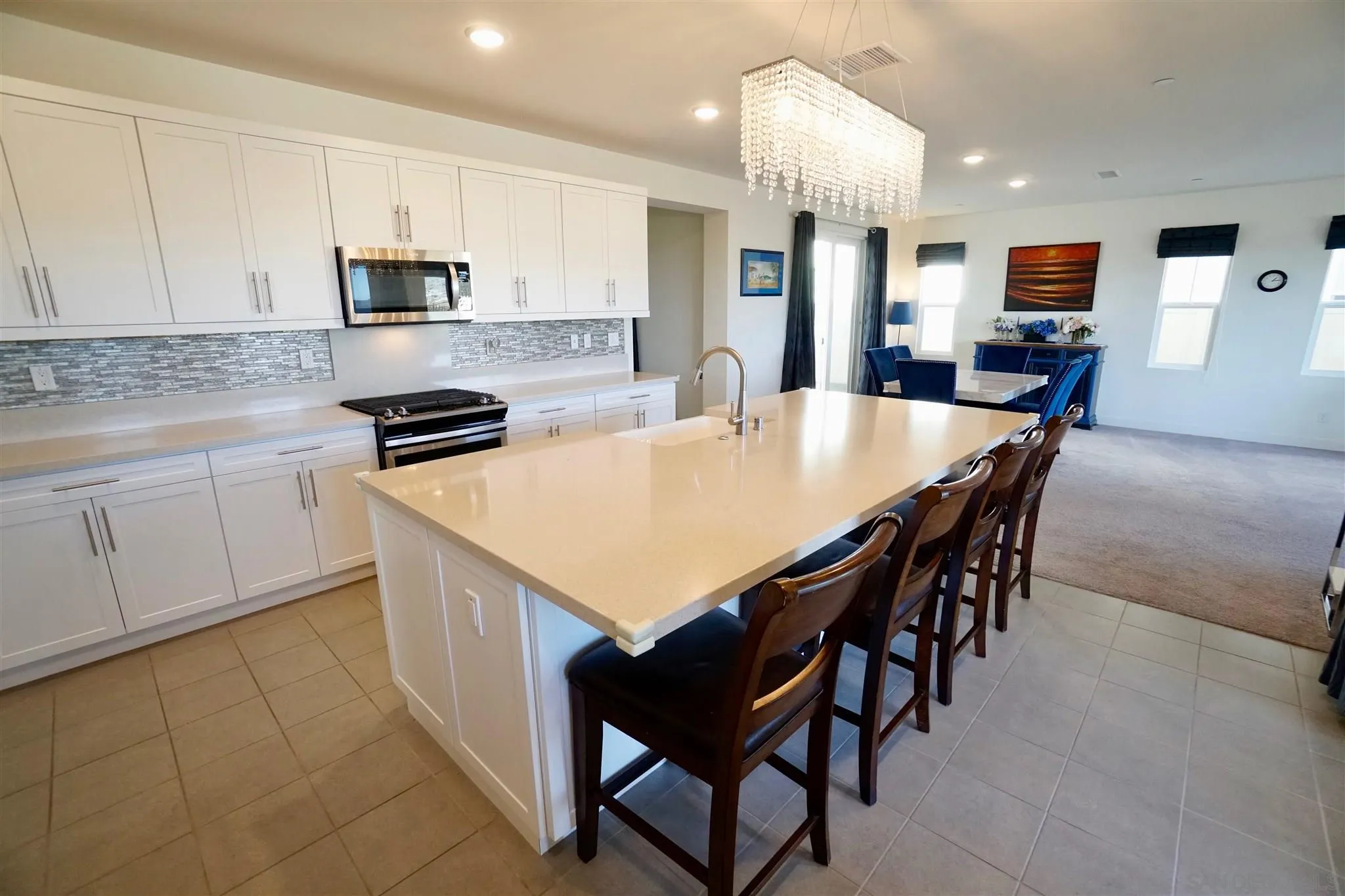 8831 Weston Road Santee, CA 92071 - Photo 9 of 25 a kitchen with stainless steel appliances kitchen island granite countertop a table chairs sink and cabinets