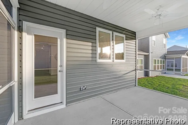 a view of a porch with a table and chairs