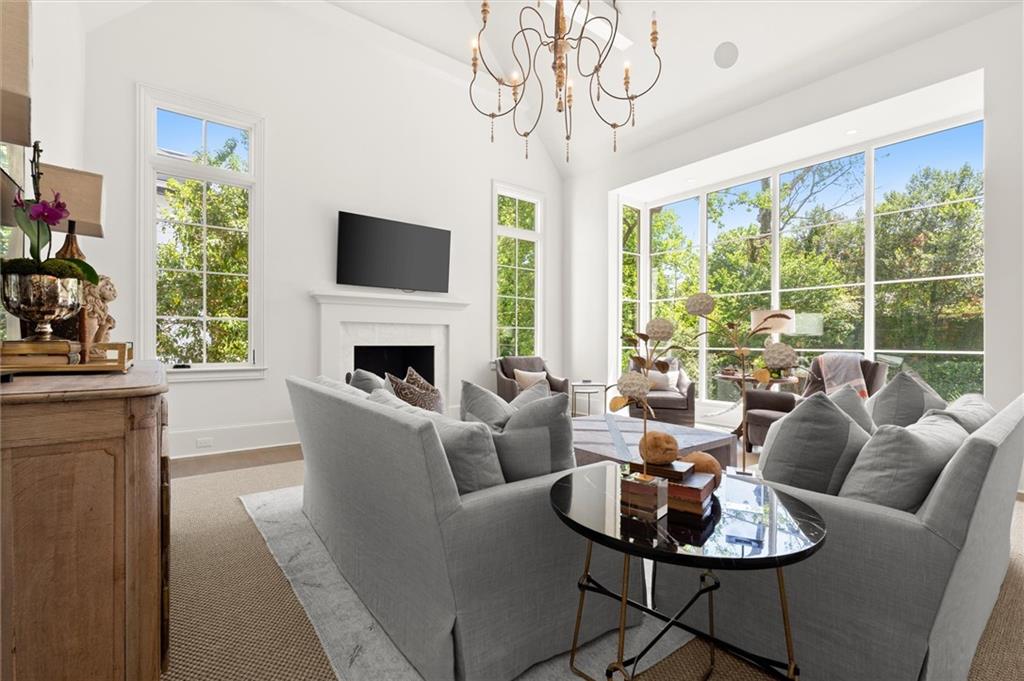 4240 Paces Ferry Road Southeast Atlanta, GA 30339 - Photo 13 of 66 a living room with furniture a large window and a fireplace