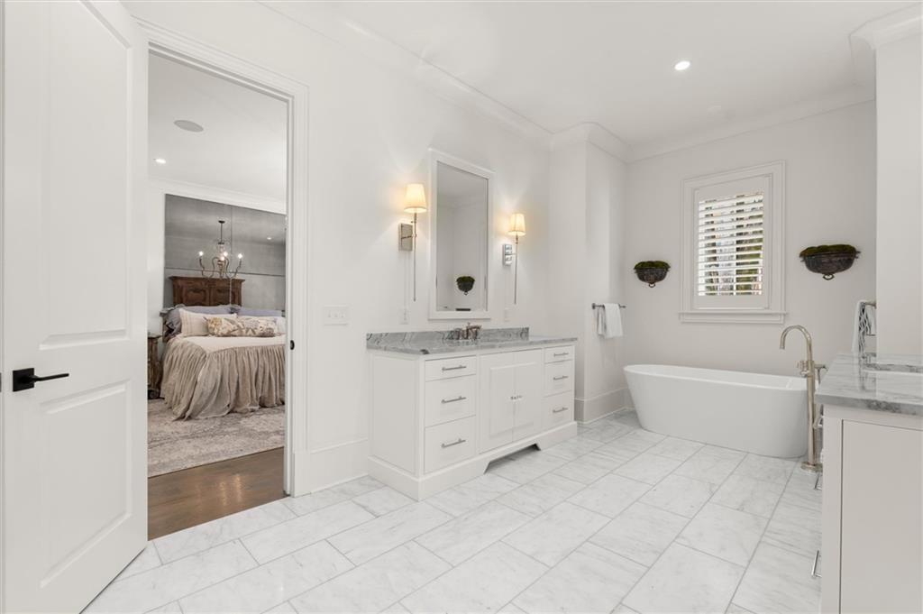 4240 Paces Ferry Road Southeast Atlanta, GA 30339 - Photo 31 of 66 a bathroom with a tub sink and mirror