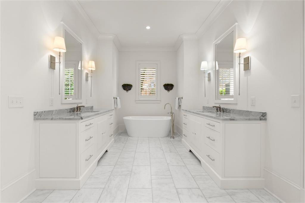 4240 Paces Ferry Road Southeast Atlanta, GA 30339 - Photo 32 of 66 a spacious bathroom with a granite countertop sink a mirror and a bathtub