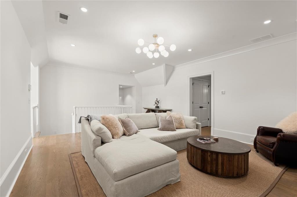 4240 Paces Ferry Road Southeast Atlanta, GA 30339 - Photo 47 of 66 a living room with furniture and a chandelier