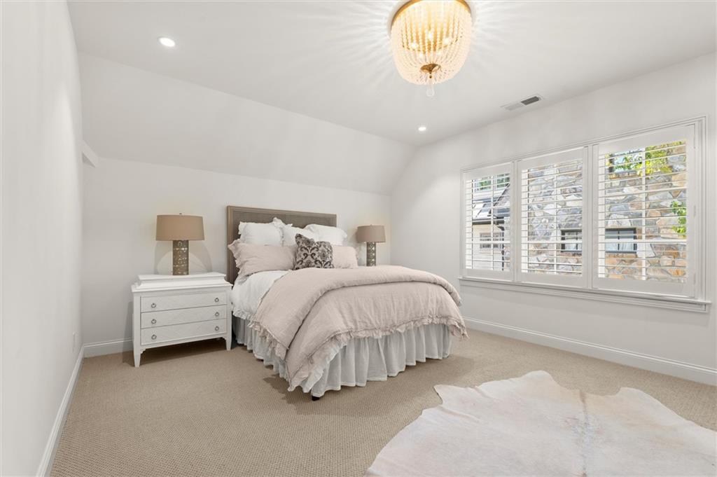 4240 Paces Ferry Road Southeast Atlanta, GA 30339 - Photo 48 of 66 a spacious bedroom with a bed and a large window