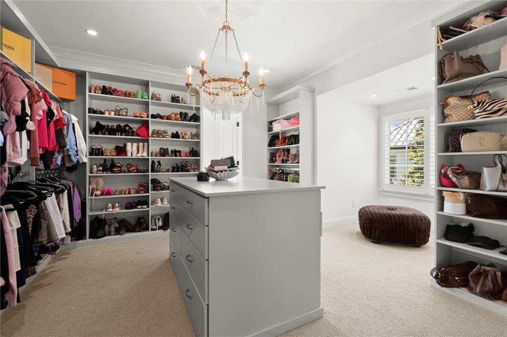 4240 Paces Ferry Road Southeast Atlanta, GA 30339 - Photo 51 of 66 a view of walk in closet with clothes and shoes