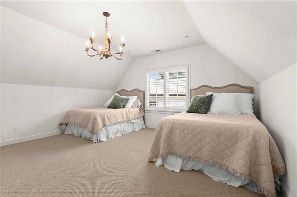 4240 Paces Ferry Road Southeast Atlanta, GA 30339 - Photo 57 of 66 a bedroom with bed and a chandelier