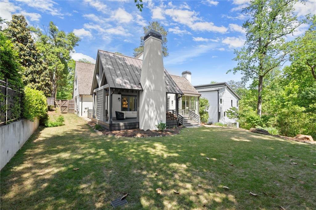 4240 Paces Ferry Road Southeast Atlanta, GA 30339 - Photo 61 of 66 a front view of a house with a garden and yard