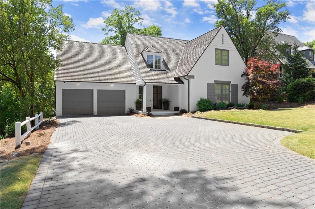 4240 Paces Ferry Road Southeast Atlanta, GA 30339 - Photo 65 of 66 a front view of a house with a yard and garage