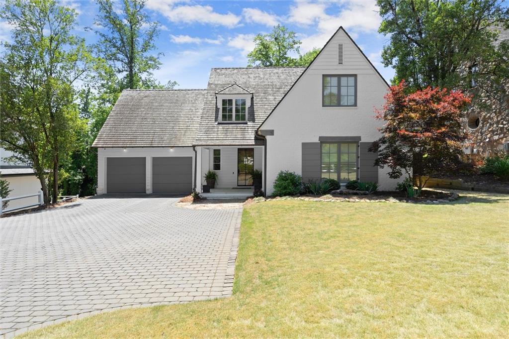 4240 Paces Ferry Road Southeast Atlanta, GA 30339 - Photo 66 of 66 a front view of a house with a yard and garage