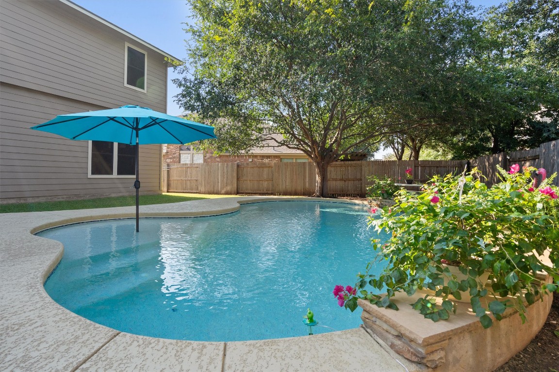 1425 Naranjo Drive Georgetown, TX 78628 - Photo 1 of 38 Backyard paradise: sparkling custom pool with peaceful fountain