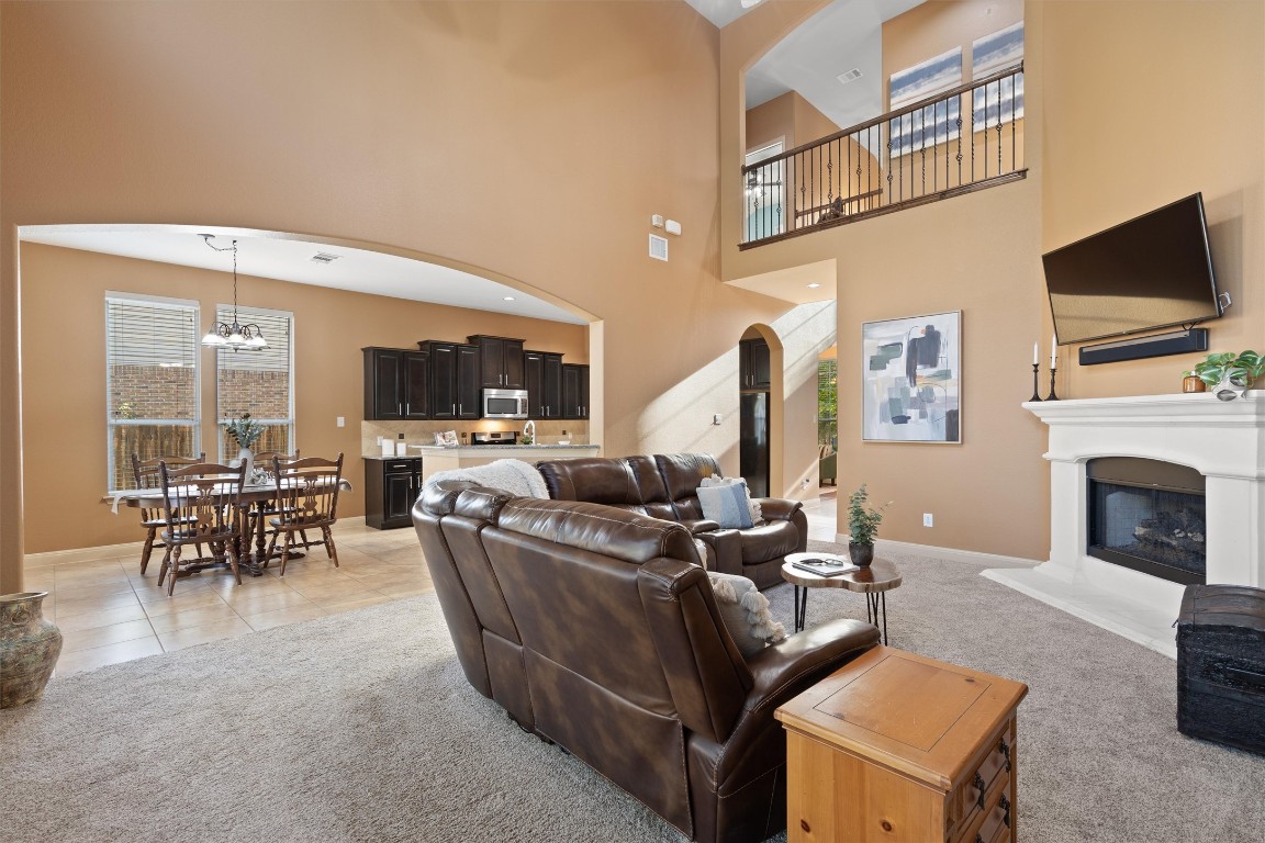 1425 Naranjo Drive Georgetown, TX 78628 - Photo 12 of 38 a living room with furniture a fireplace and a flat screen tv