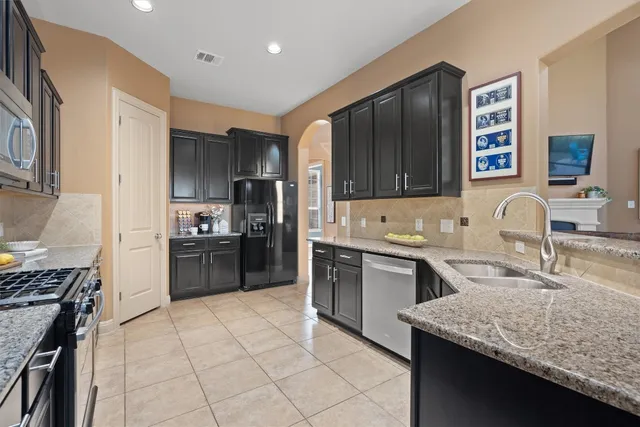 a kitchen with a sink stove and refrigerator