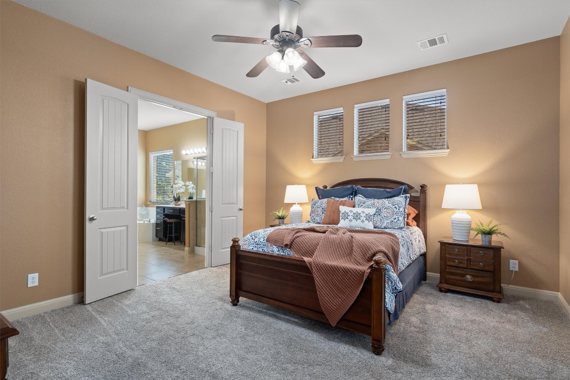 1425 Naranjo Drive Georgetown, TX 78628 - Photo 18 of 38 a bedroom with bed and a chandelier