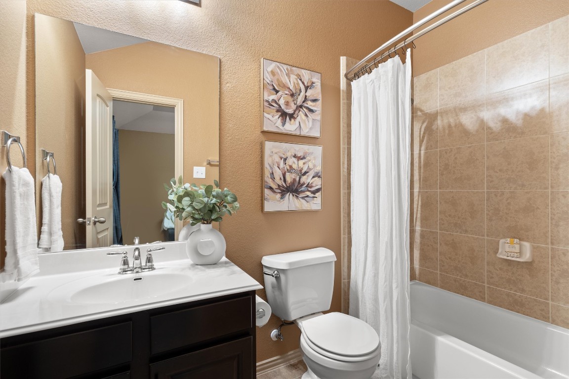 1425 Naranjo Drive Georgetown, TX 78628 - Photo 22 of 38 a bathroom with a sink a toilet and a large mirror