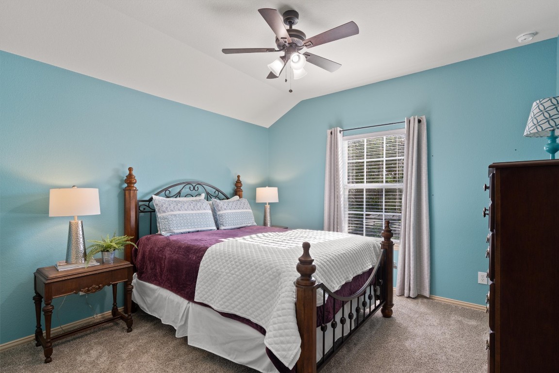 1425 Naranjo Drive Georgetown, TX 78628 - Photo 23 of 38 a bedroom with a bed and a chandelier