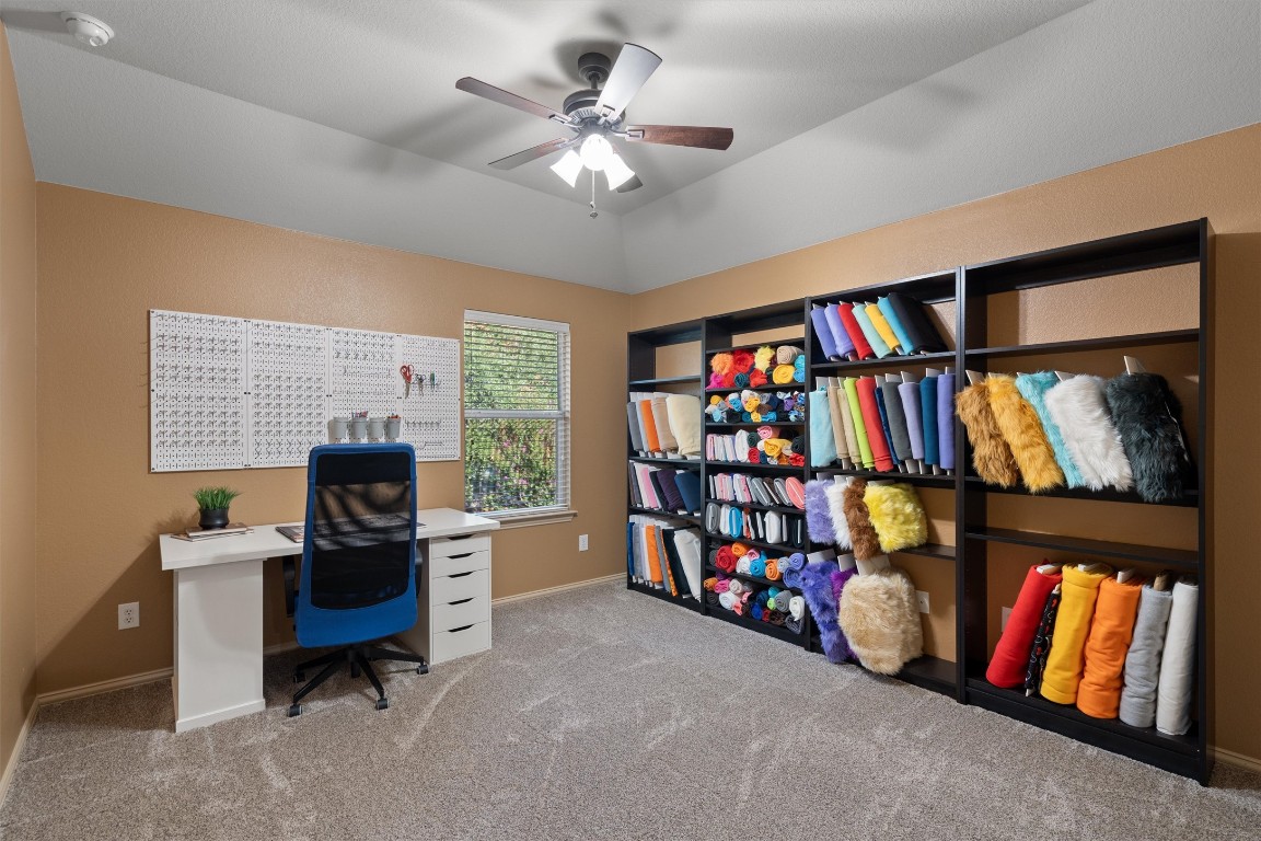 1425 Naranjo Drive Georgetown, TX 78628 - Photo 24 of 38 a view of a workspace with furniture and a bookshelf