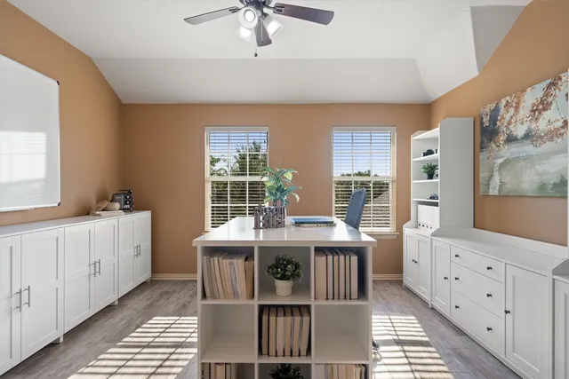 a view of a workspace with furniture and a bookshelf