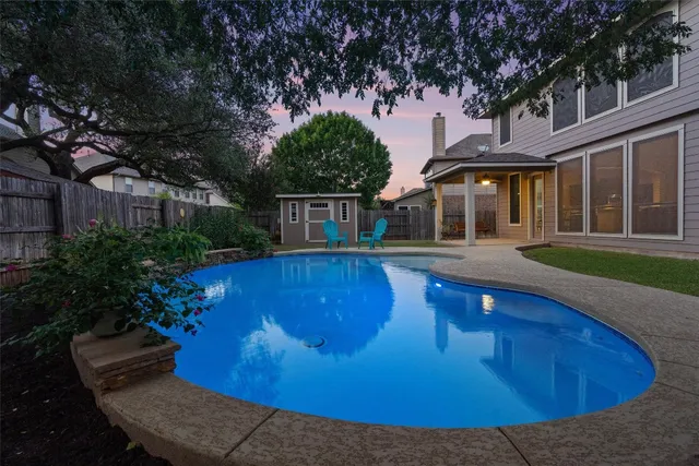 a view of a house with swimming pool and porch with furniture