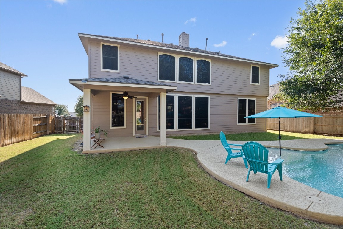 1425 Naranjo Drive Georgetown, TX 78628 - Photo 31 of 38 a patio with a table and chairs under an umbrella