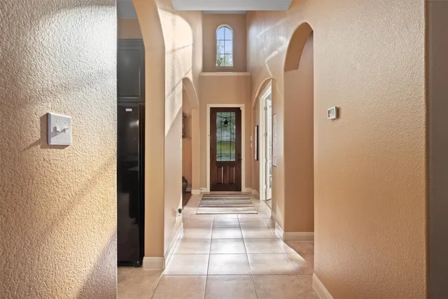 a view of a room that has a door and a mirror