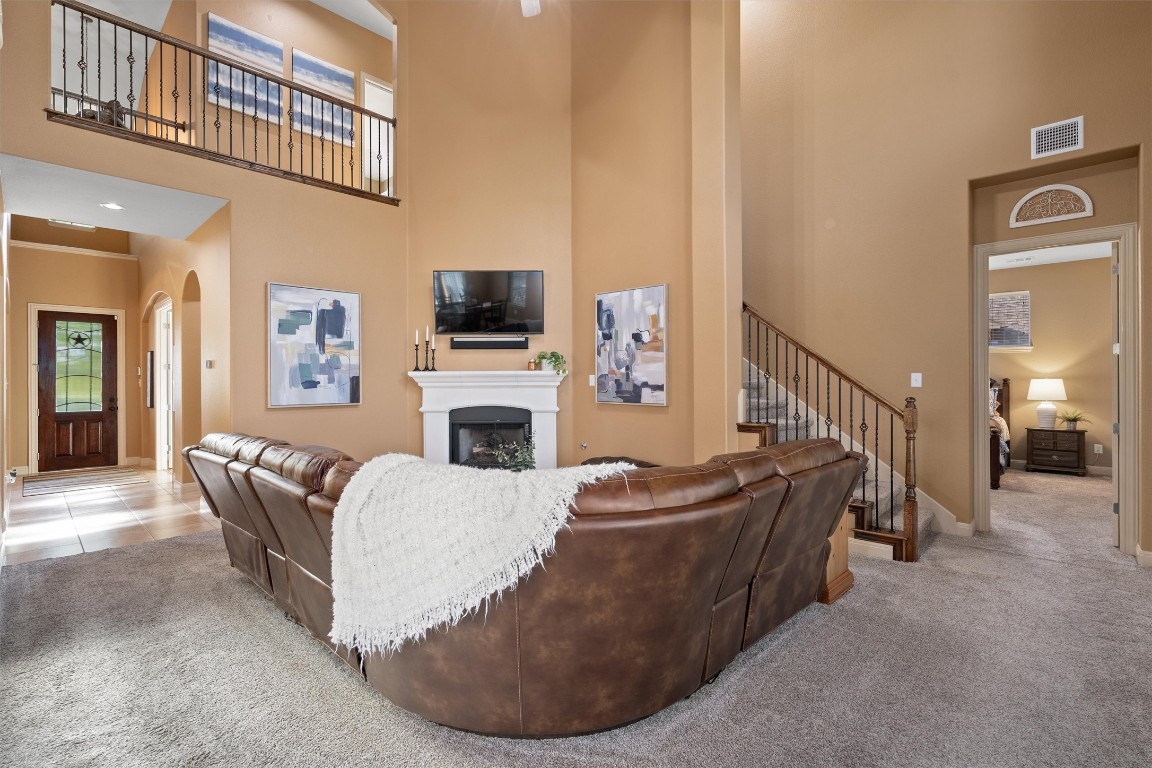 1425 Naranjo Drive Georgetown, TX 78628 - Photo 10 of 38 a living room with furniture a fireplace and a flat screen tv