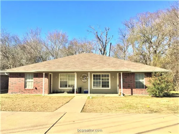 a house that has a tree in front of it