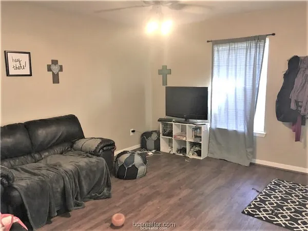 a living room with furniture and a flat screen tv