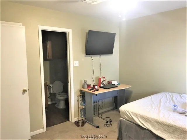 a room with a table chairs and entryway