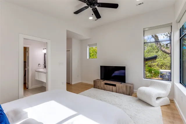 a bedroom with a bed and a television