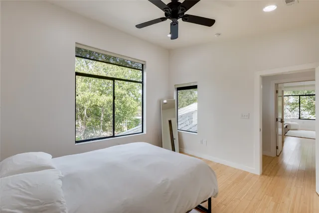 a bedroom with a large bed and a window
