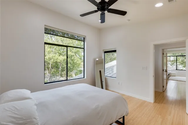 a bedroom with a large bed and a window