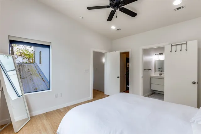 a bedroom with a bed and a mirror