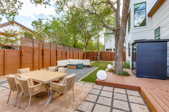 a view of a patio with a table and chairs