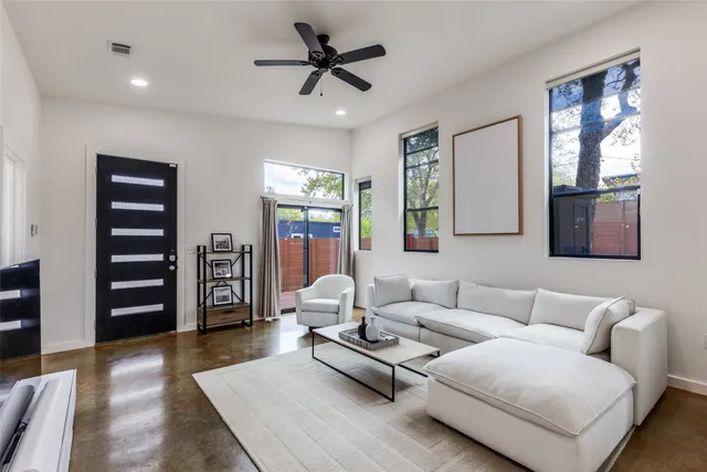 a living room with furniture and wooden floor