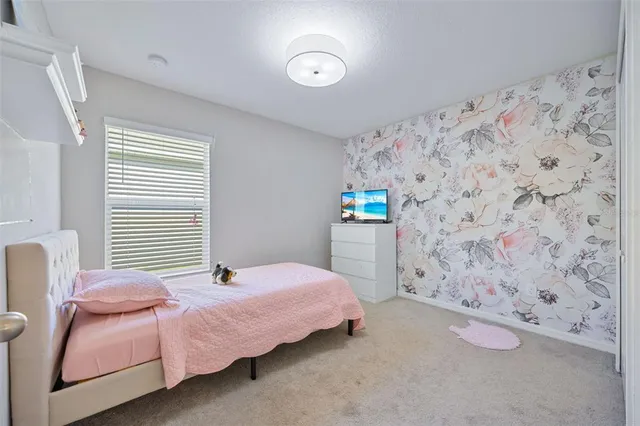 a bedroom with a bed dresser and a window