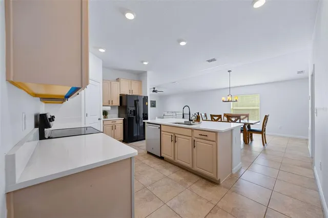 a kitchen with a sink a counter top space and stainless steel appliances