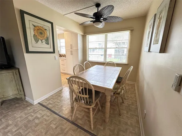 a view of a dining room with furniture and a window