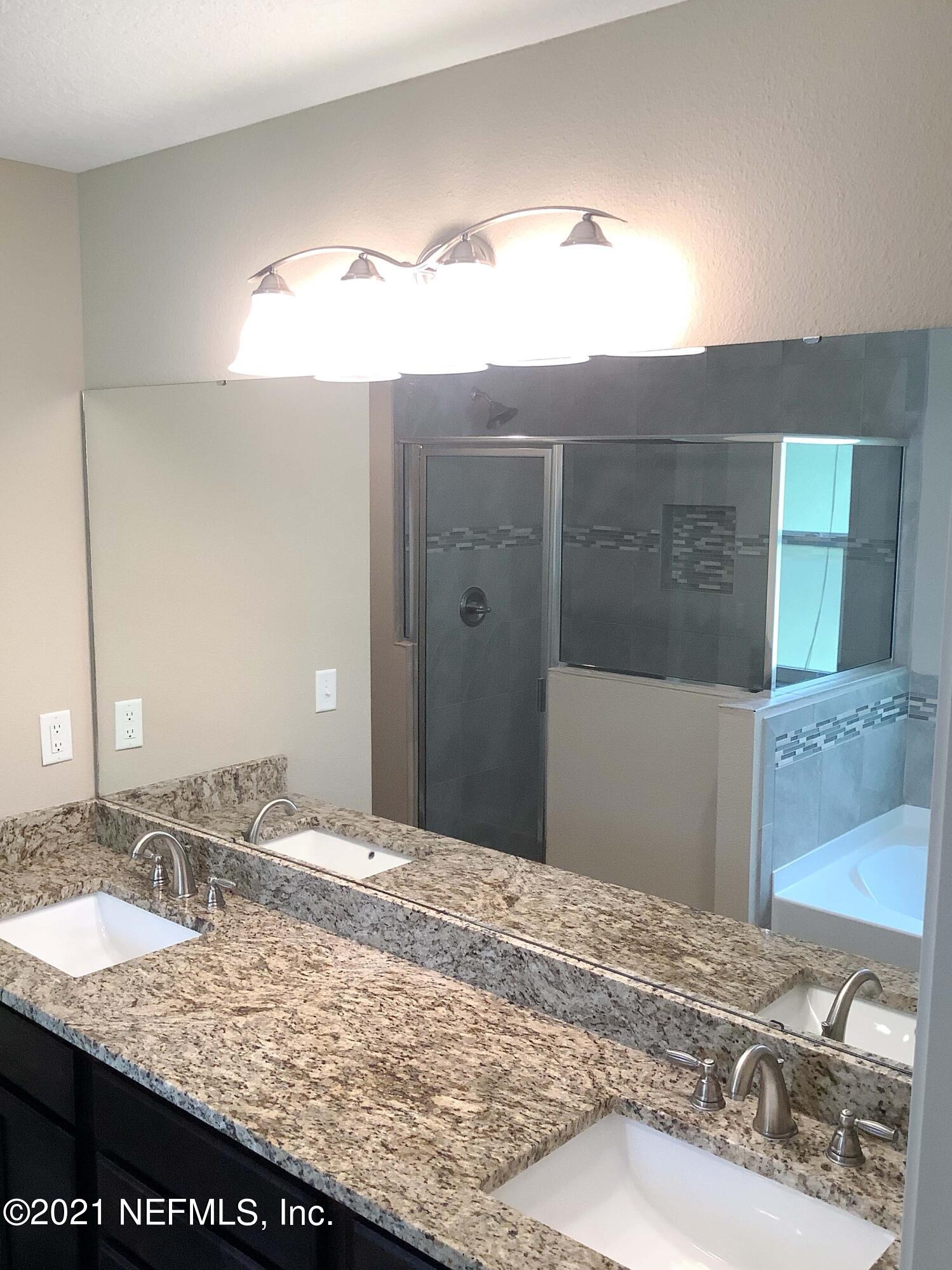 1579 Lockend Road Jacksonville, FL 32221 - Photo 11 of 15 a bathroom with a granite countertop sink and a mirror