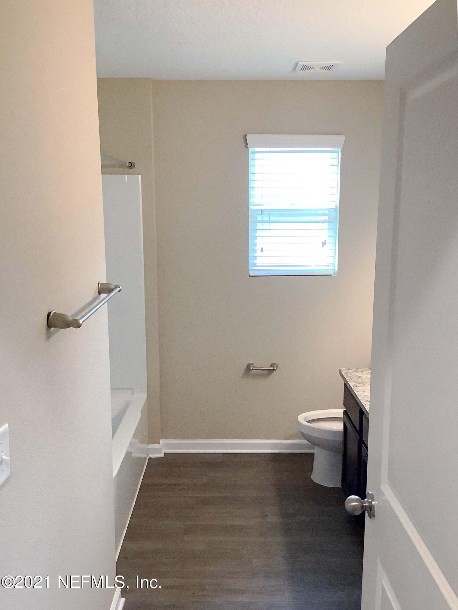 1579 Lockend Road Jacksonville, FL 32221 - Photo 6 of 15 a bathroom with a toilet a sink and a window