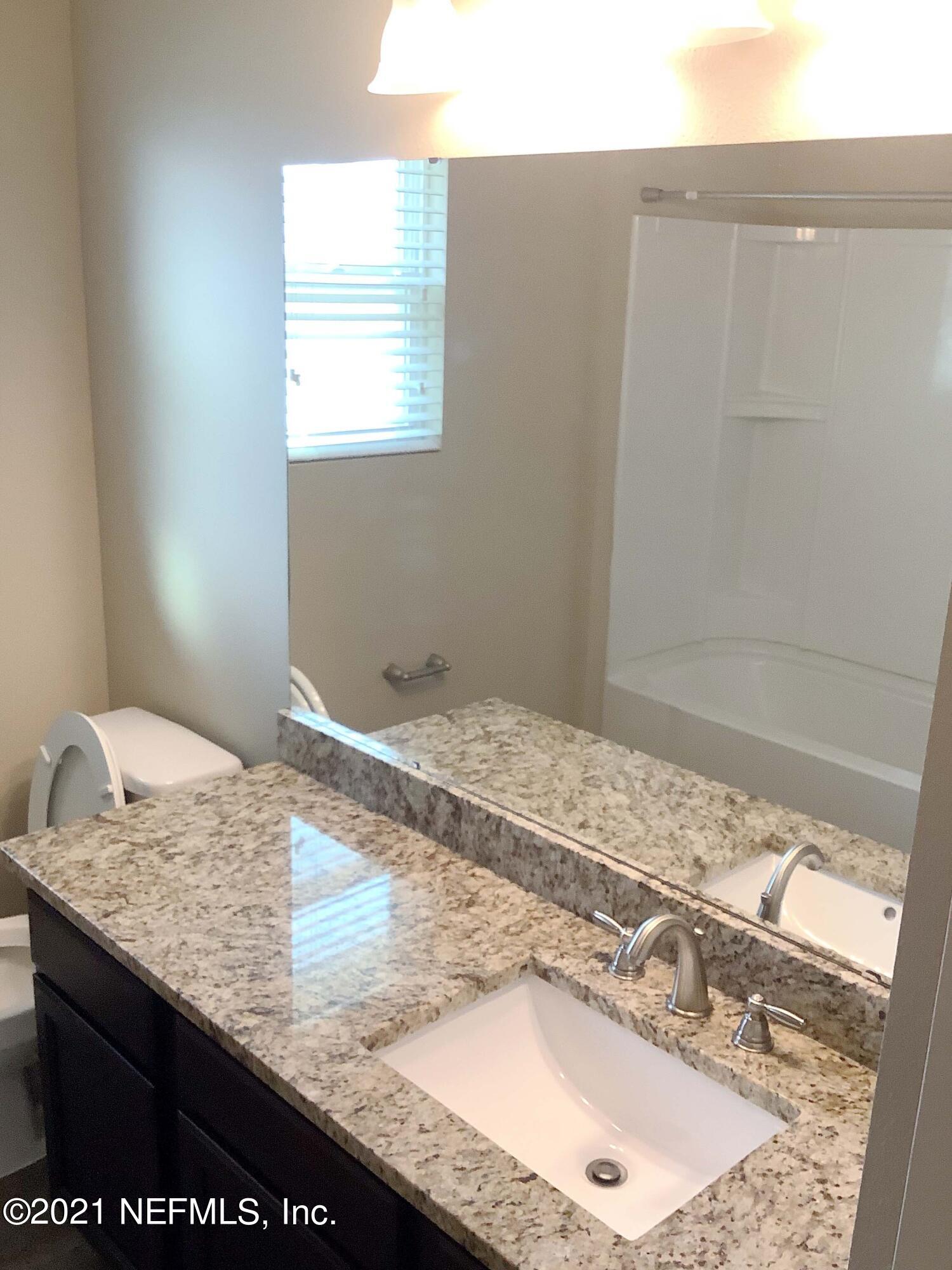 1579 Lockend Road Jacksonville, FL 32221 - Photo 7 of 15 a bathroom with a granite countertop sink and a granite