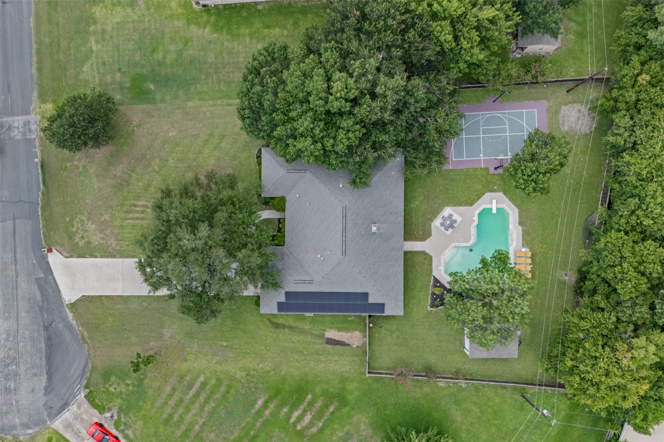 2000 Spinel Road Pflugerville, TX 78660 - Photo 29 of 31 An aerial perspective reveals a private pool, a basketball court, and ample green space for outdoor leisure.