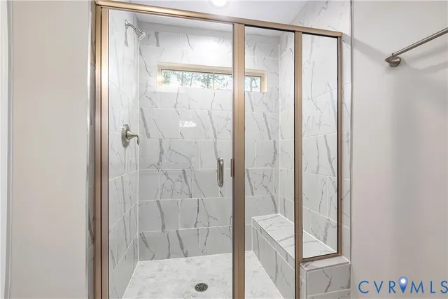 a bathroom with a glass shower door